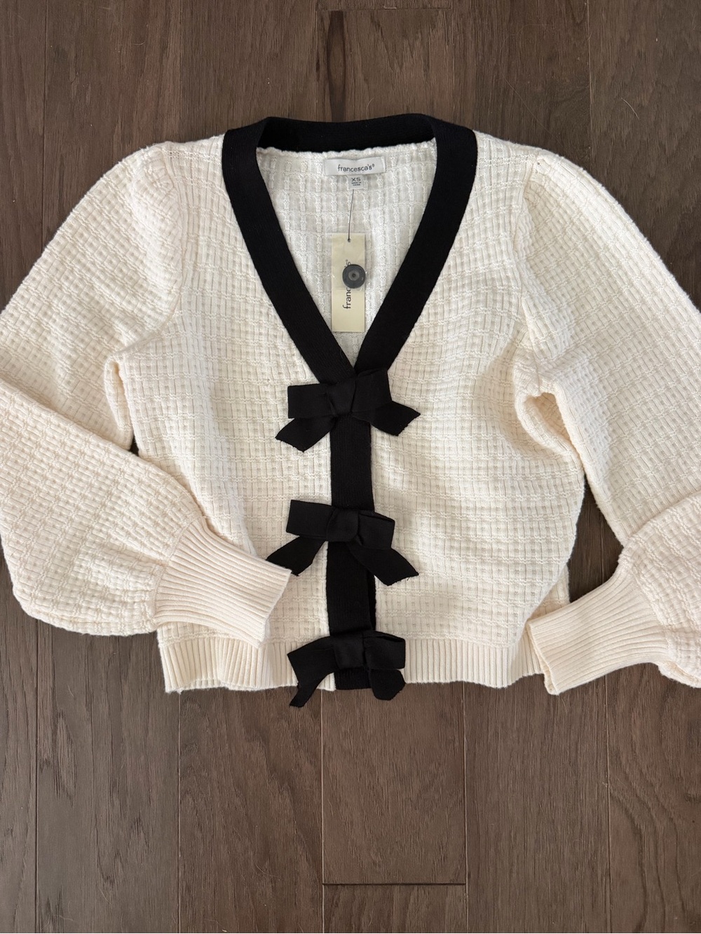 Francesca's Collections Cream Knit Cardigan with Black Trim and Bow Details